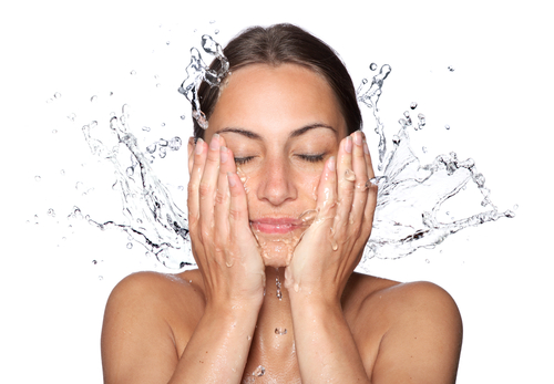 Lady cleansing or washing her acne-prone face Lady cleansing or washing her acne-prone face